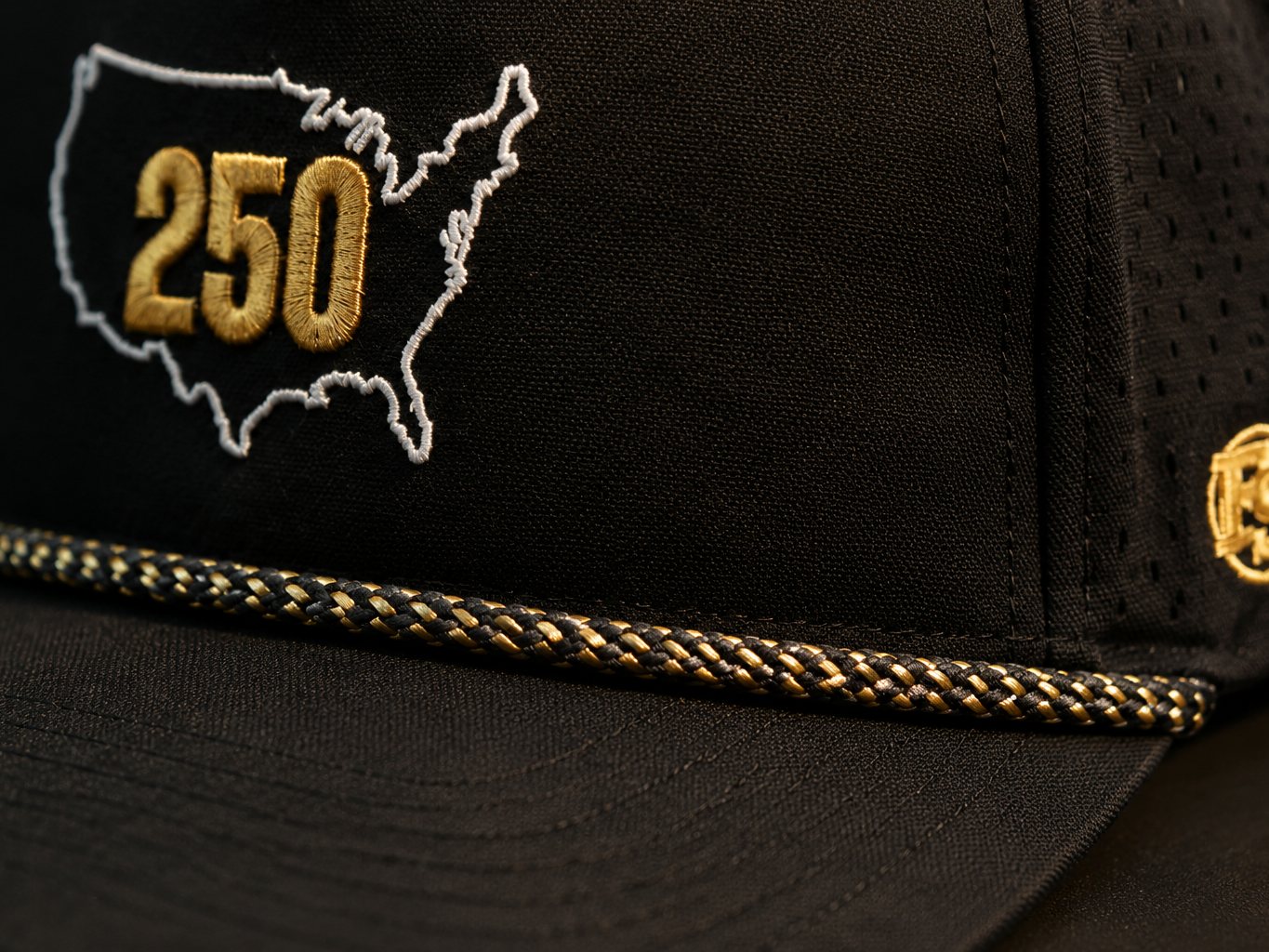 Close-up of the black and gold braided rope on the USA 250 snapback